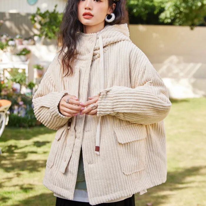 Still life of silver jewelry arranged with petals and leaves, softly lit against a dark deep blue background, reflecting elegance, nature, and artistic inspiration.